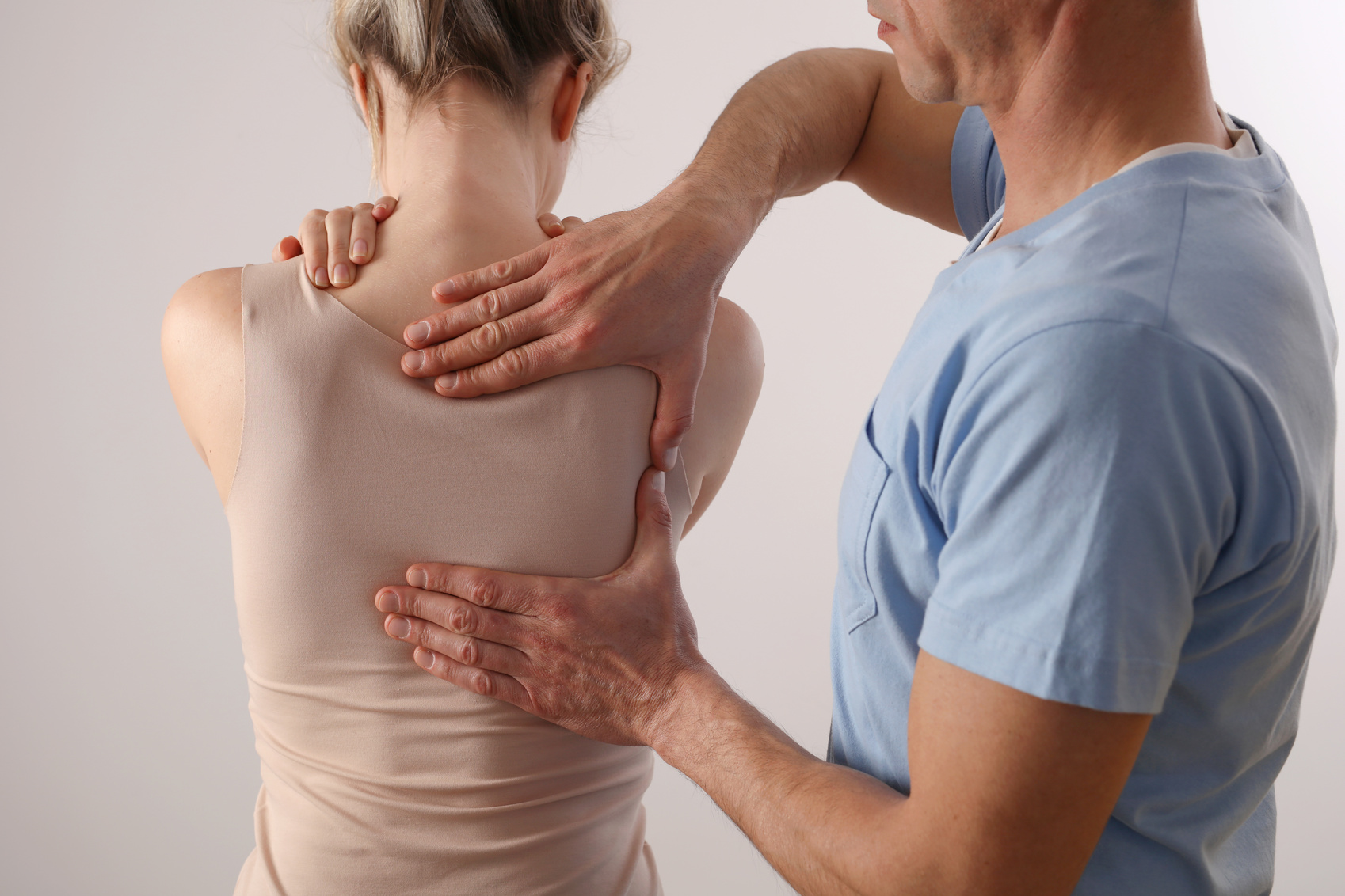 Woman having Chiropractic Back Adjustment / Physiotherapy treatment . Posture Correction, Scoliosis examination for female patient .